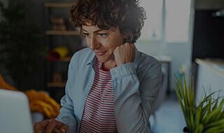 Middle Aged Woman At Laptop Mobile