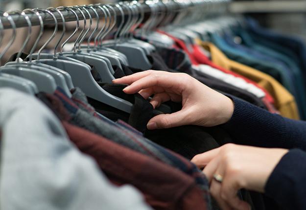 Person choosing looking for outfit in closet