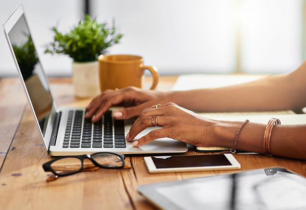 Woman using laptop and smartphone