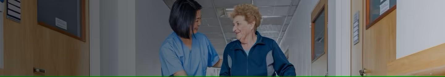 Nurse helping an old lady to walk with her walker
