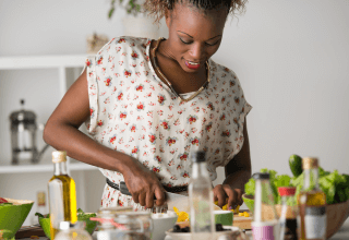 Woman preparing a meal at her kitchen