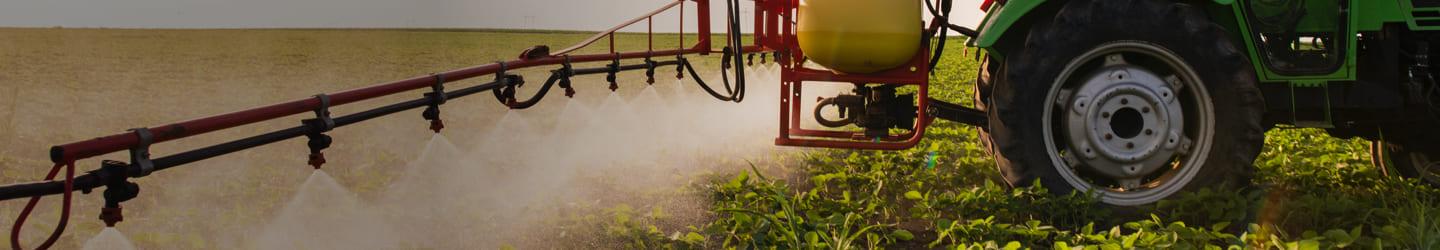 Farmer watering crops with a tractor