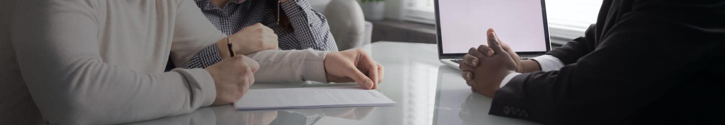 Banker attending a couple at an office desk