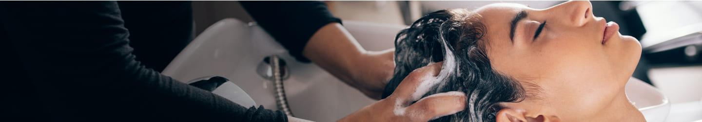 Woman getting he hair washed at a salon