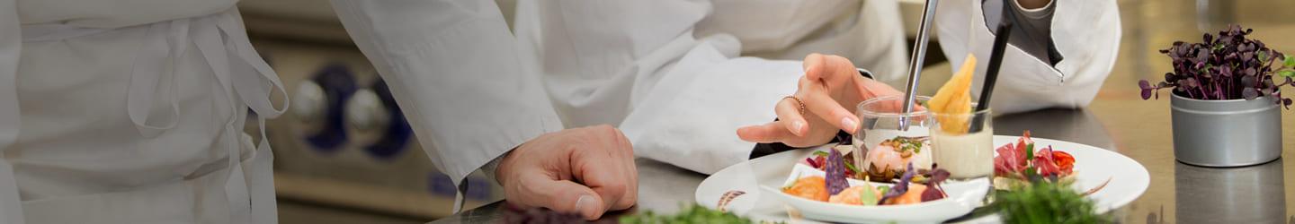 Chefs preparing a fine dinner plate