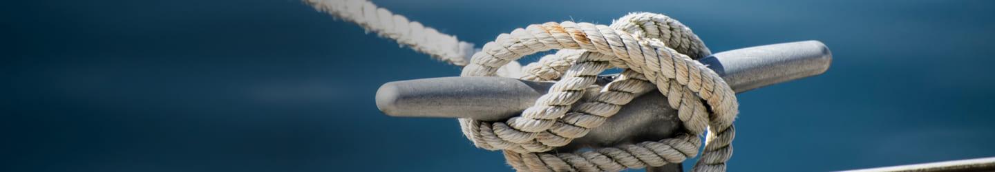 Sailor knot holding a boat in bay