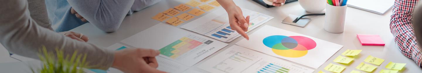 Group of people analyzing charts on a table