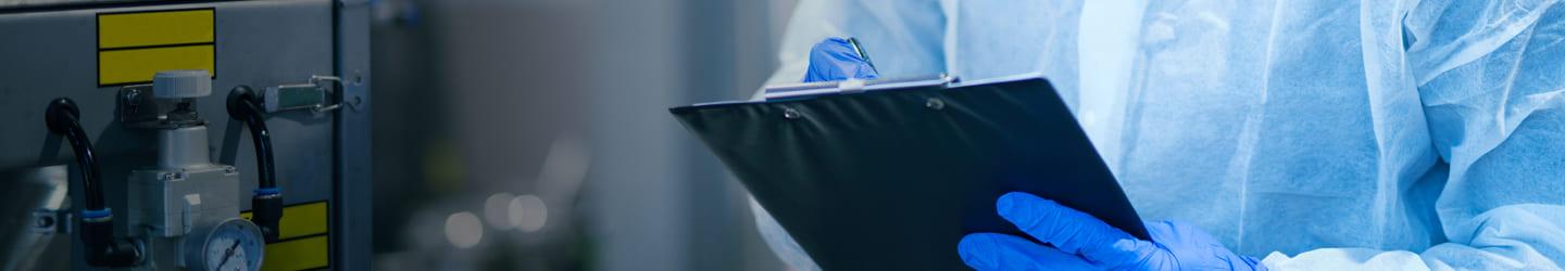 Man in protective gear examining products