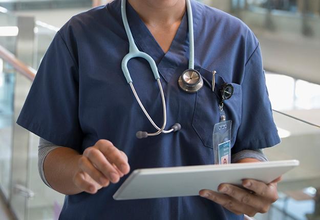 Female nurse with tablet in hospital