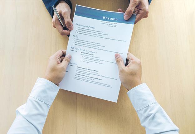 Man handing out his resume to an interviewer