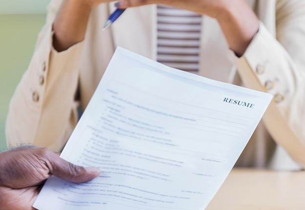 Man holding resume in an interview