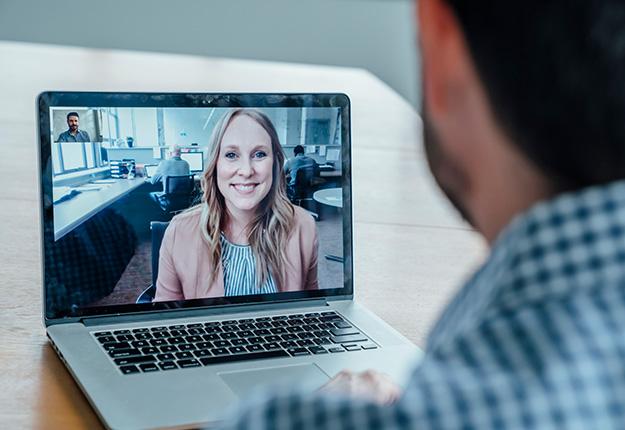 Man talkin to woman through laptop