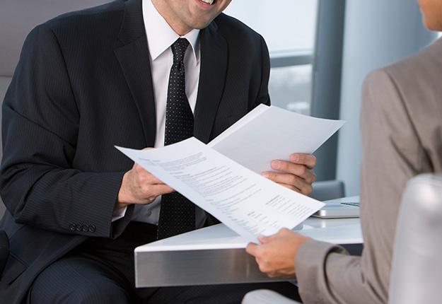Man and woman in an interview holding resume