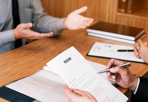 Recruiter looking at a resume during a meeting