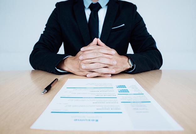 Businessman with resume on table