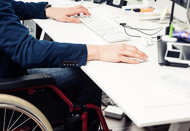 Businessman sitting on a wheelchair working