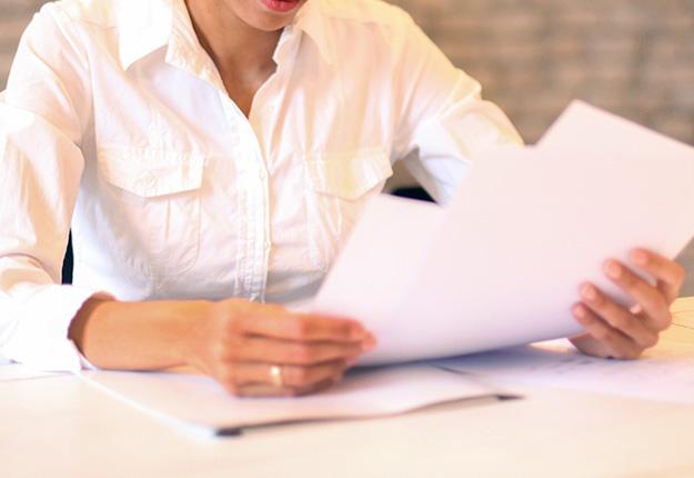 Woman looking at resume pages