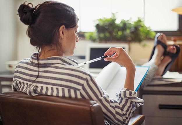 Woman reading a paper and thinking