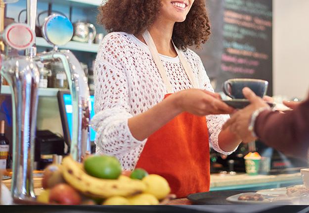 Woman working as a cashier in a coffee shop