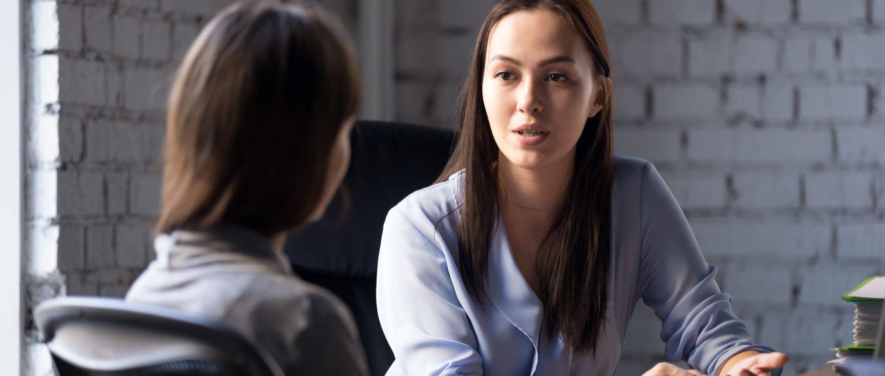 Counselor woman speaking to her client in an office