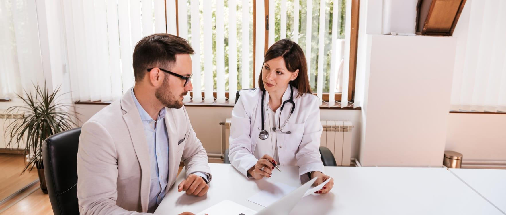 Businessman reviewing papers with a female doctor