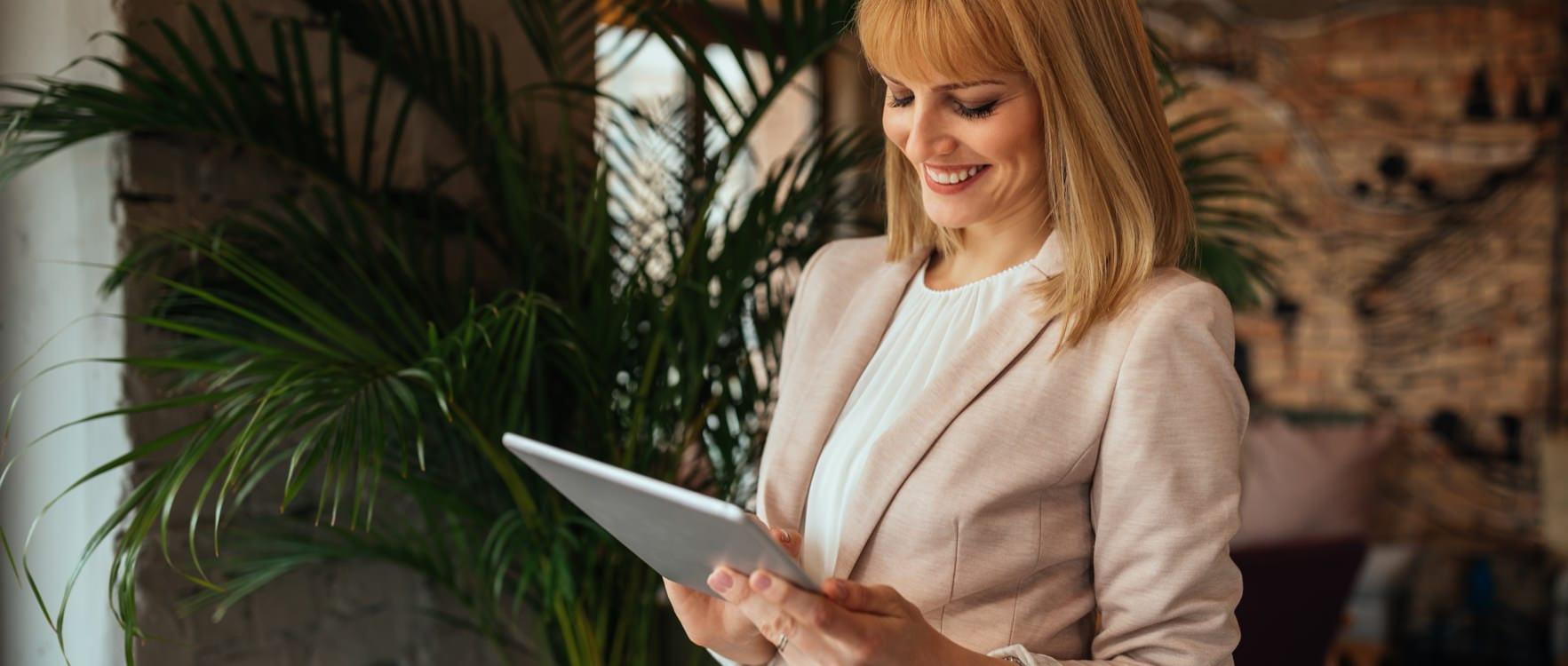 Businesswoman using a tablet at a hotel lobby