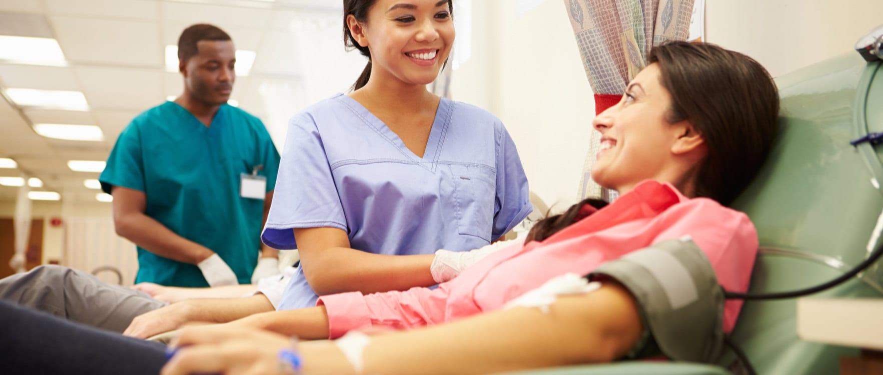 Female nurse prepping a patient for a blood donation