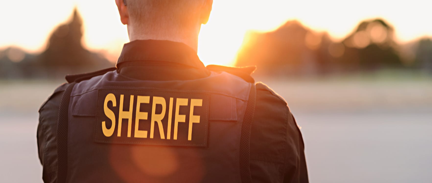 Officer wearing a bullet vest with the word Sheriff