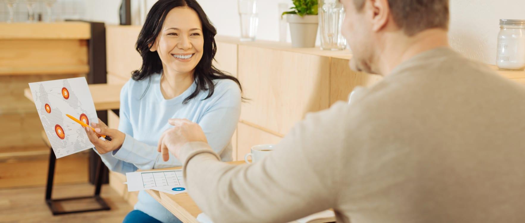 Woman showing a graph on a paper to a man