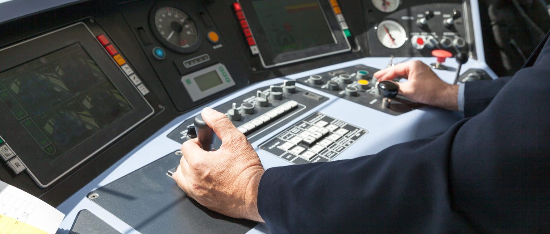 Man in a suit operating a train console