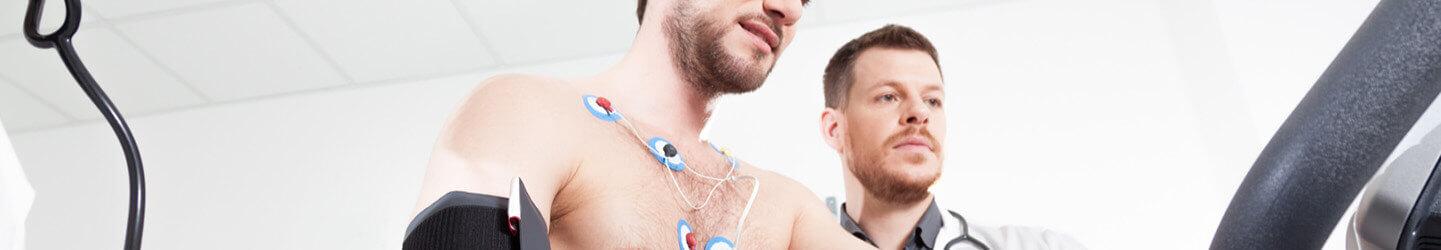 A male doctor conducting endurance test and putting electrodes on a man