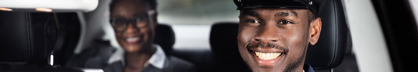 Close-up Of Happy Male Chauffeur Driving Car