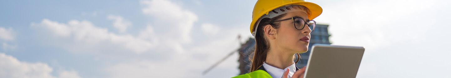 A Female civil engineer monitoring something at construction site