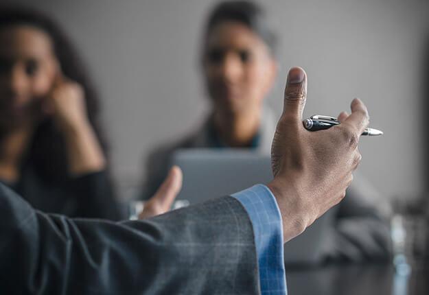 Businessman gesturing to attentive audience