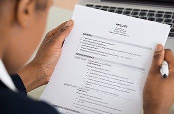 Businessman reading a resume at his desk