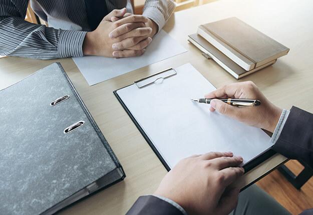 Two businessmen in an interview one of them taking notes