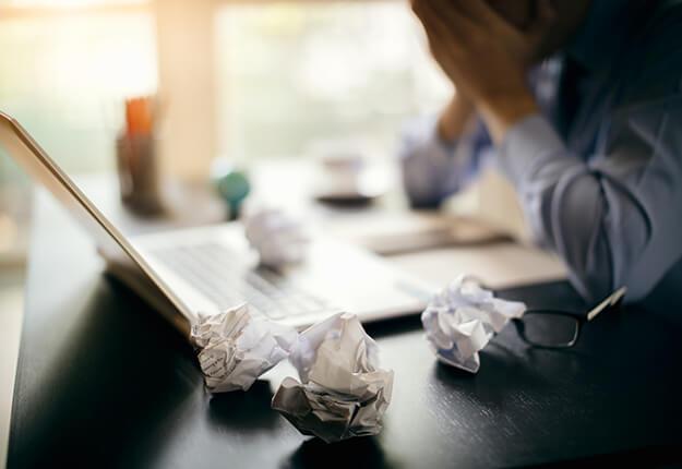 Businessman frustrated in desk with laptop