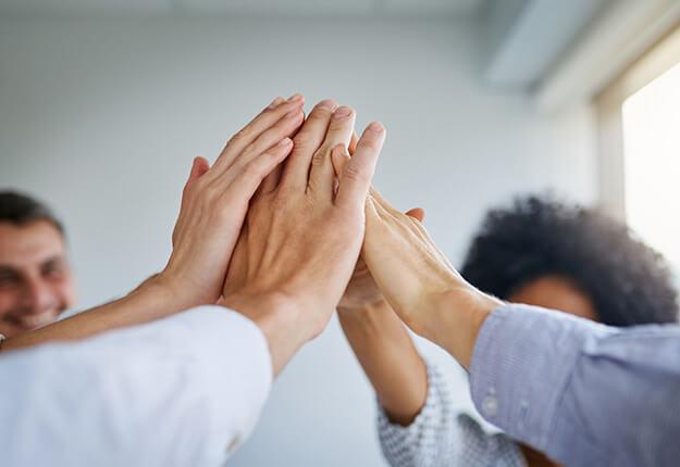Team of people high-fiving