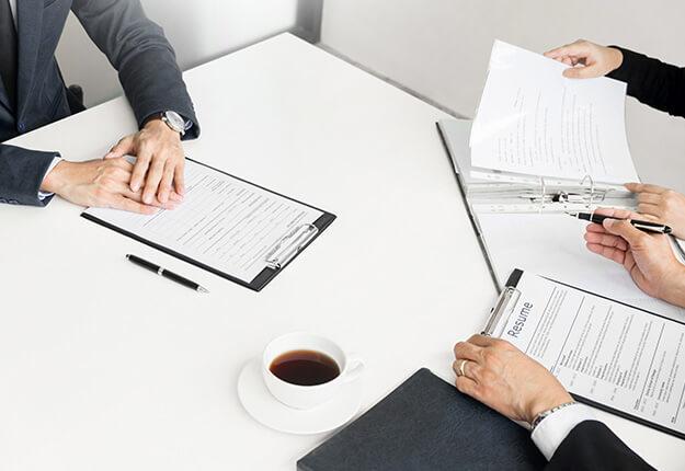 Job interview with businessman taking notes