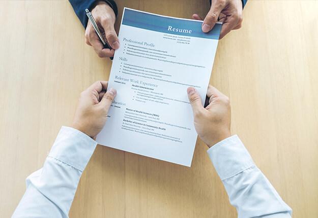 Man handing out his resume to an interviewer