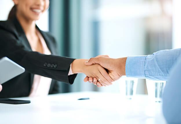 Business man and women happily shaking hands