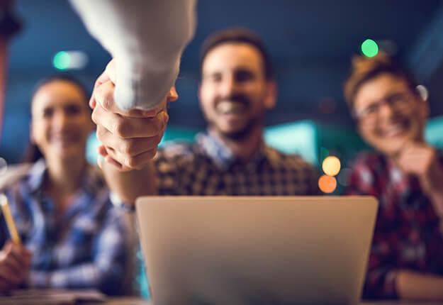 People shaking hands in an interview