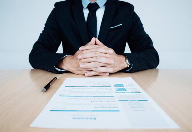 Businessman with resume on table