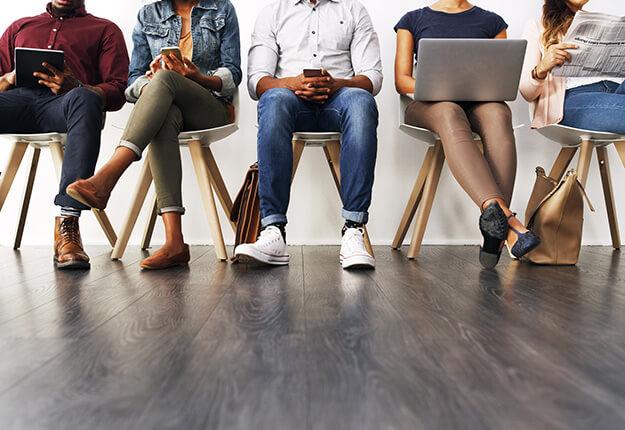 People sitting down waiting in different postures