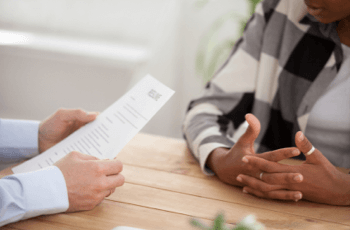 Businessman intervieweing a candidate resume on desk
