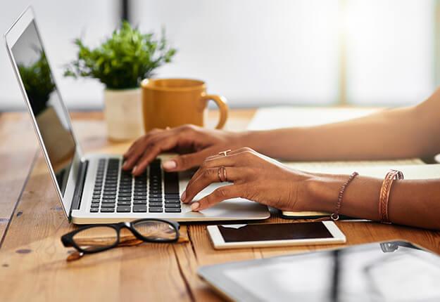 Woman using laptop and smartphone