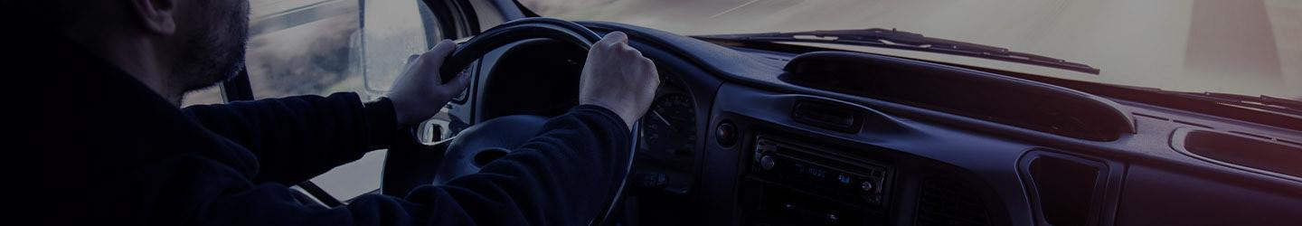 Man driving a truck on a highway