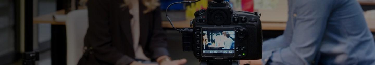 woman journalist interviewing with camera