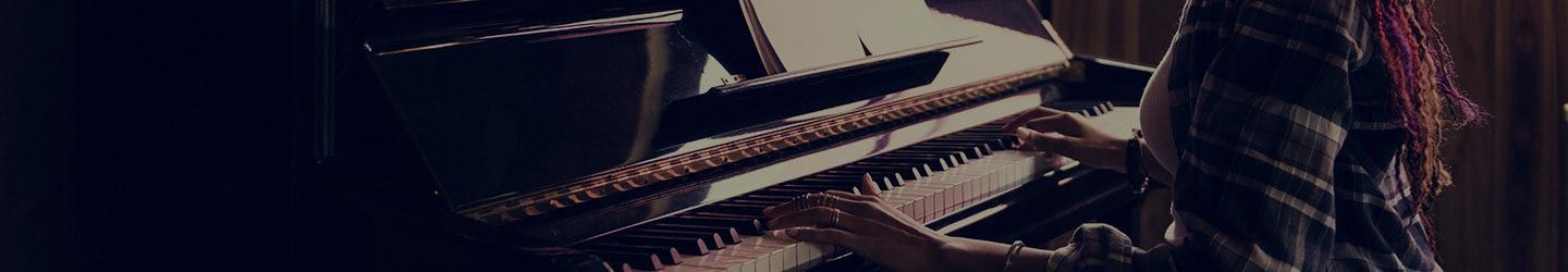 Woman playing piano at a music school