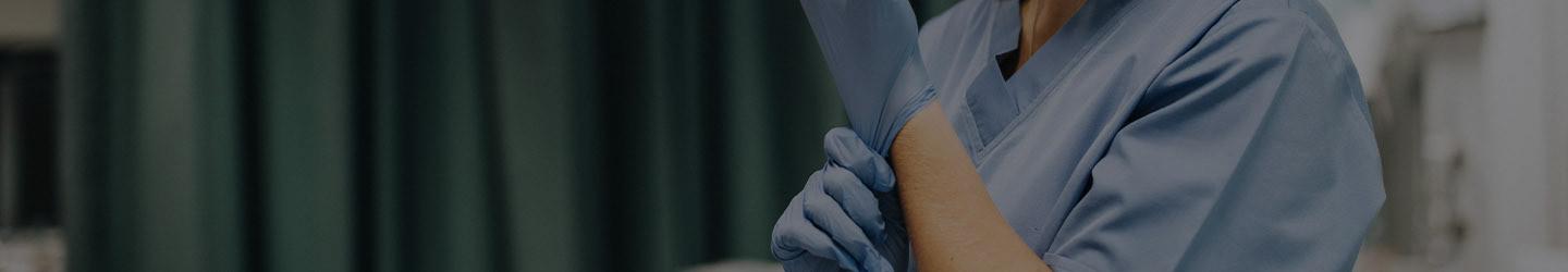 Nurse putting on gloves at a hospital